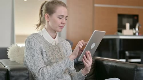 Woman Using Tablet Device Indoors at Home