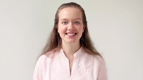 Smiling Woman Wearing a Pink Shirt