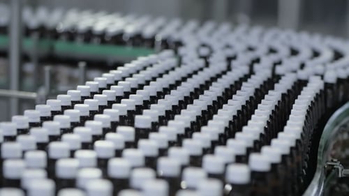 Many Plastic Bottles Moving on Conveyor