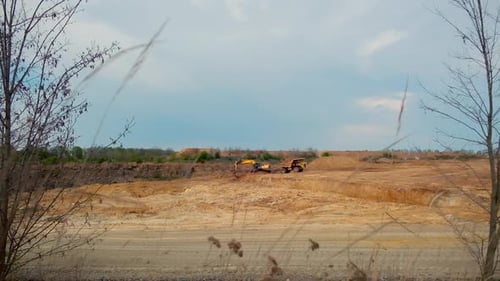 Excavator working on earthmoving at quarry. Tracked excavator in quarry
