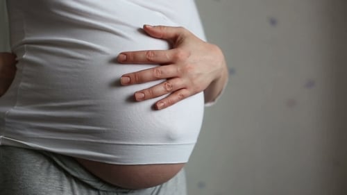Pregnant Woman Holding Her Belly, Close Up