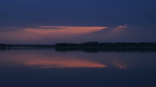 Tranquil Sunset Reflected in Calm Lake Water