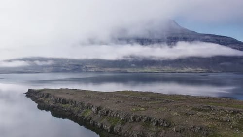Drone Flight Over Lake With Low Cloud And Mountains