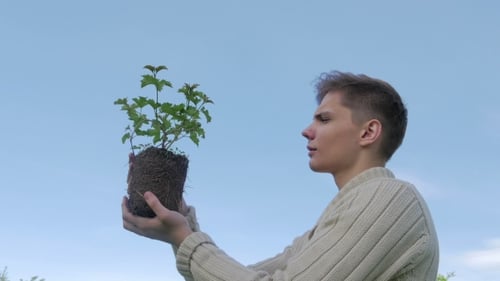 Man Holding Plant