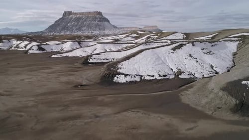 Flying low and fast over rugged desert terrain as snow melts