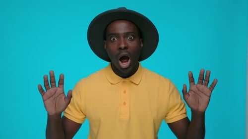 Surprised Man with Open Hands on Blue Background