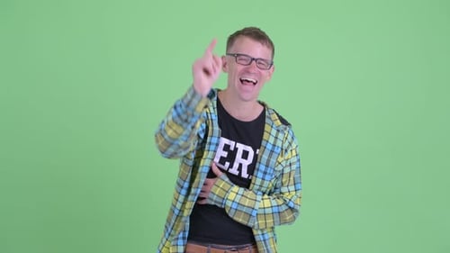 Man Laughing and Pointing in Front of Green Screen