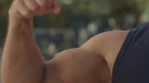 Close-up of Muscular Bodybuilder Showing Bicep