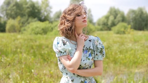 Woman Posing in Floral Dress in Natural Setting