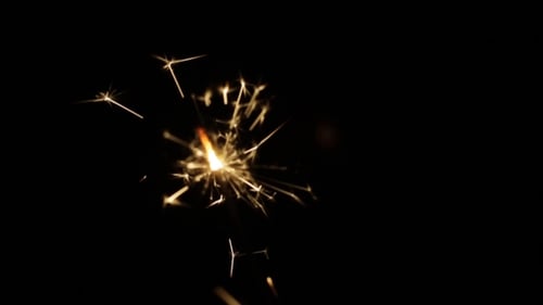 Sparkler Burning with Bright Sparks on Black