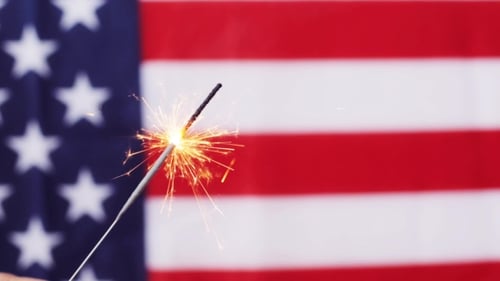 Sparkler Burning in Front of American Flag