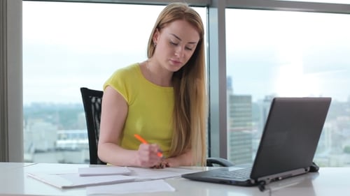 The Girl Working With Laptop In The Office