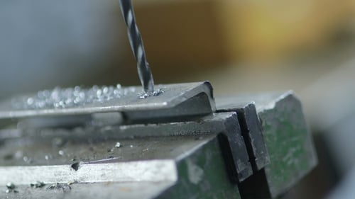 Worker Drilling Metal At Workshop