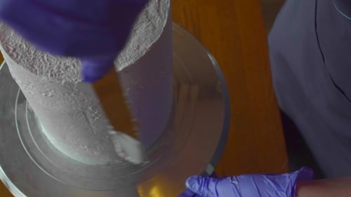 Icing Cake with Pale Pink Frosting Close Up