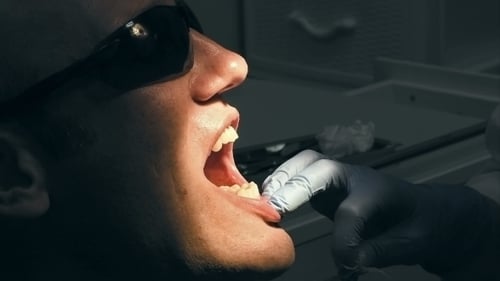 Dentist Working on Patient's Teeth in Office