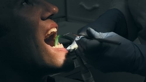 Dentist Operates on Adult Patient in Office