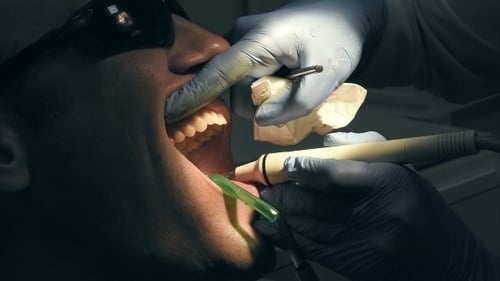 Man Gets Dental Medical Examination And Treatment