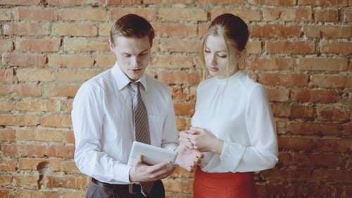 Business Professionals Reviewing Tablet Together
