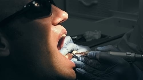 Patient Receives Dental Treatment in Clinic Close Up