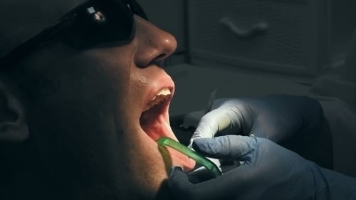 Man Receiving Dental Treatment in Medical Clinic