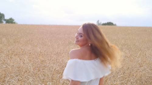 Young Woman Girl In White Dress Running On The Field