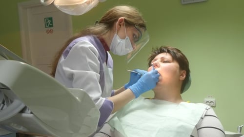 Dentist Examining Patient's Teeth in Clinic