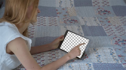 Woman Relaxes at Home Using Tablet