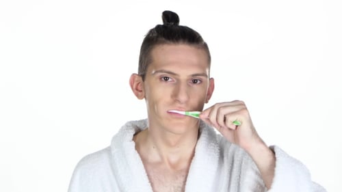 Man Brushing His Teeth. Isolated On The White Background