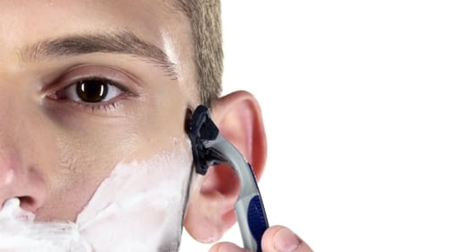 Close Up on Young Man Shaving His Face