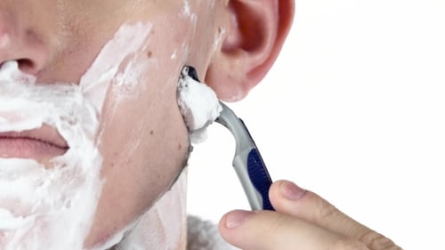 Young Adult Shaving Face Close Up