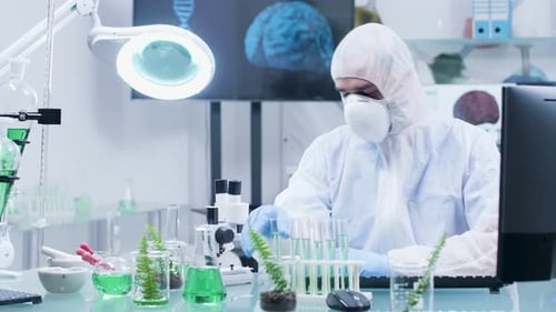 Scientist in Protective Suit Working in Laboratory
