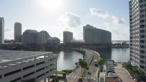 Aerial of the Road Running To the Residential Buildings. Miami in the Backlight