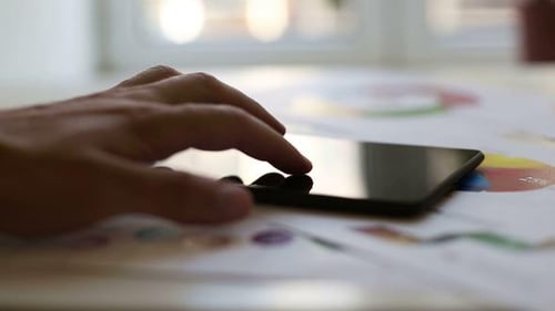 Finger Scrolls on Tablet Display Over Charts