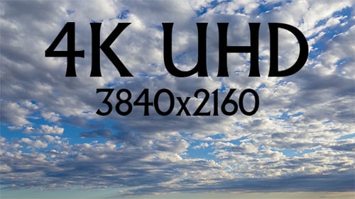 Fluffy Clouds Moving Across Vast Blue Sky