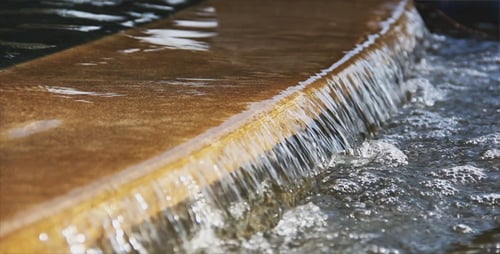 Water Cascading Over Flat Rock Surface