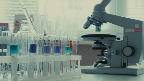 Microscope and Test Tubes in Science Laboratory