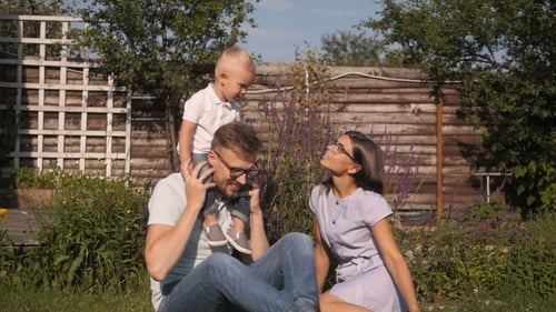 Family Enjoys Day Together Outside Home on Lawn