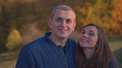 The Couple Kissing In Autumn Park.