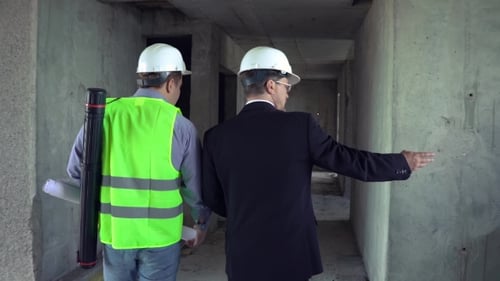 Engineers Walking Through Building Construction Site