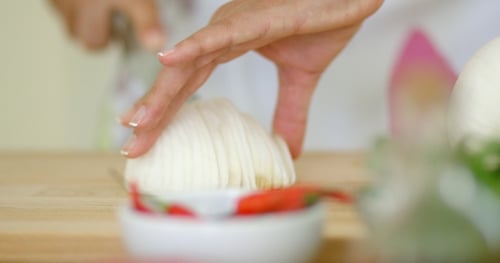 On Hands Cutting Fresh Onion