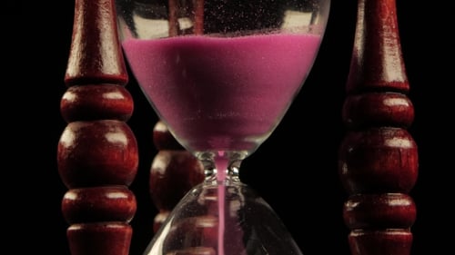 Sand Falls Through An Hourglass. Black.