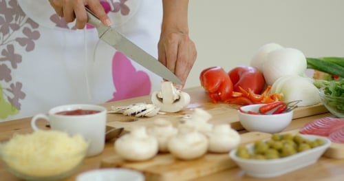 Housewife Preparing Dinner Slicing Fresh Mushrooms