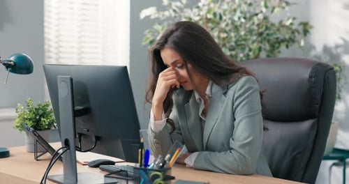 Heartbroken Sad Upset Office Worker Sits in Front of Computer Checks Bad News Large Amount of Work