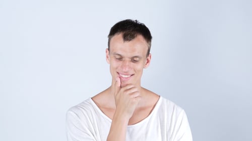 Young Man Thinking with Hand on Chin