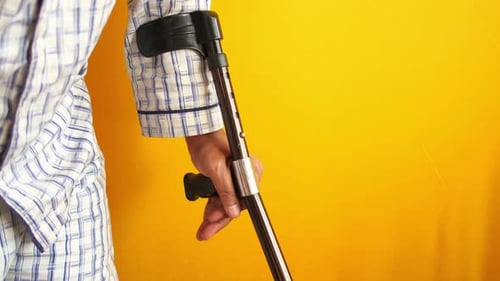 Closeup of Arm Crutch on Yellow Background