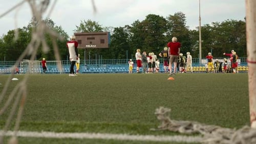 Football Team Practices on a Green Playing Field