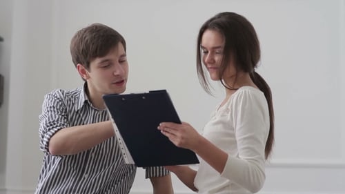 Young Adults Reviewing Documents in Office Setting
