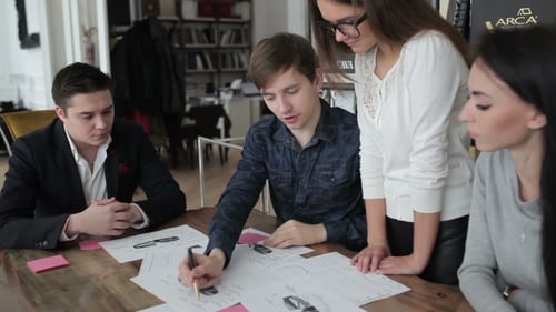 Employees Discussing Tables, Graphs And Charts.