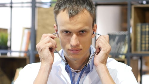 Young Adult Doctor Puts on Stethoscope
