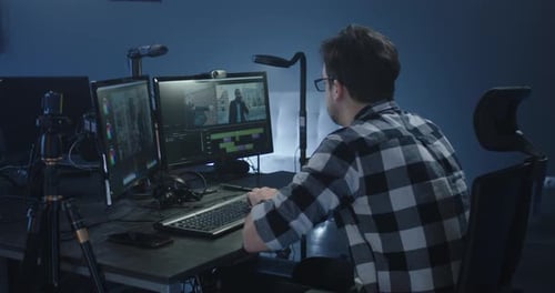 Man Working on Video Editing at Computer